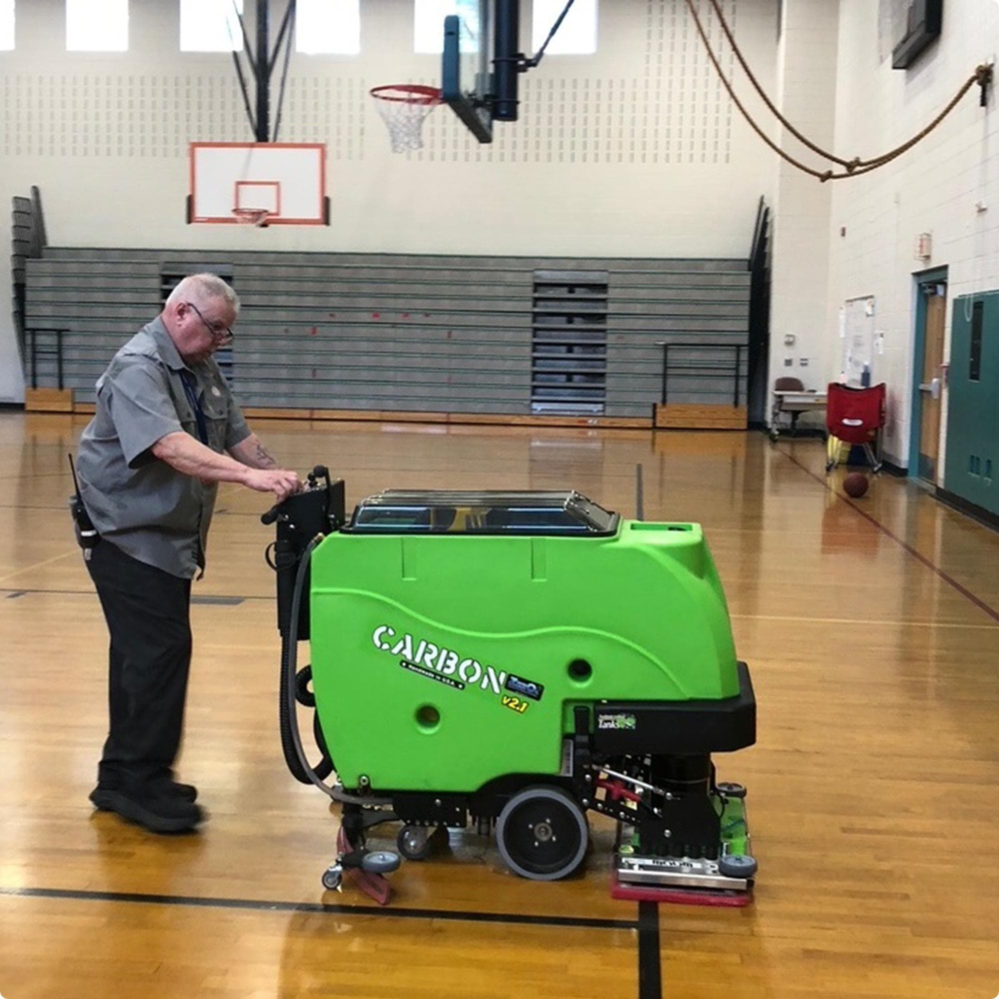 Tomcat Carbon 28" EDGE walk behind  floor scubber with anti-microbial tank option cleaning a wood floor in a gymnasium IMG0001