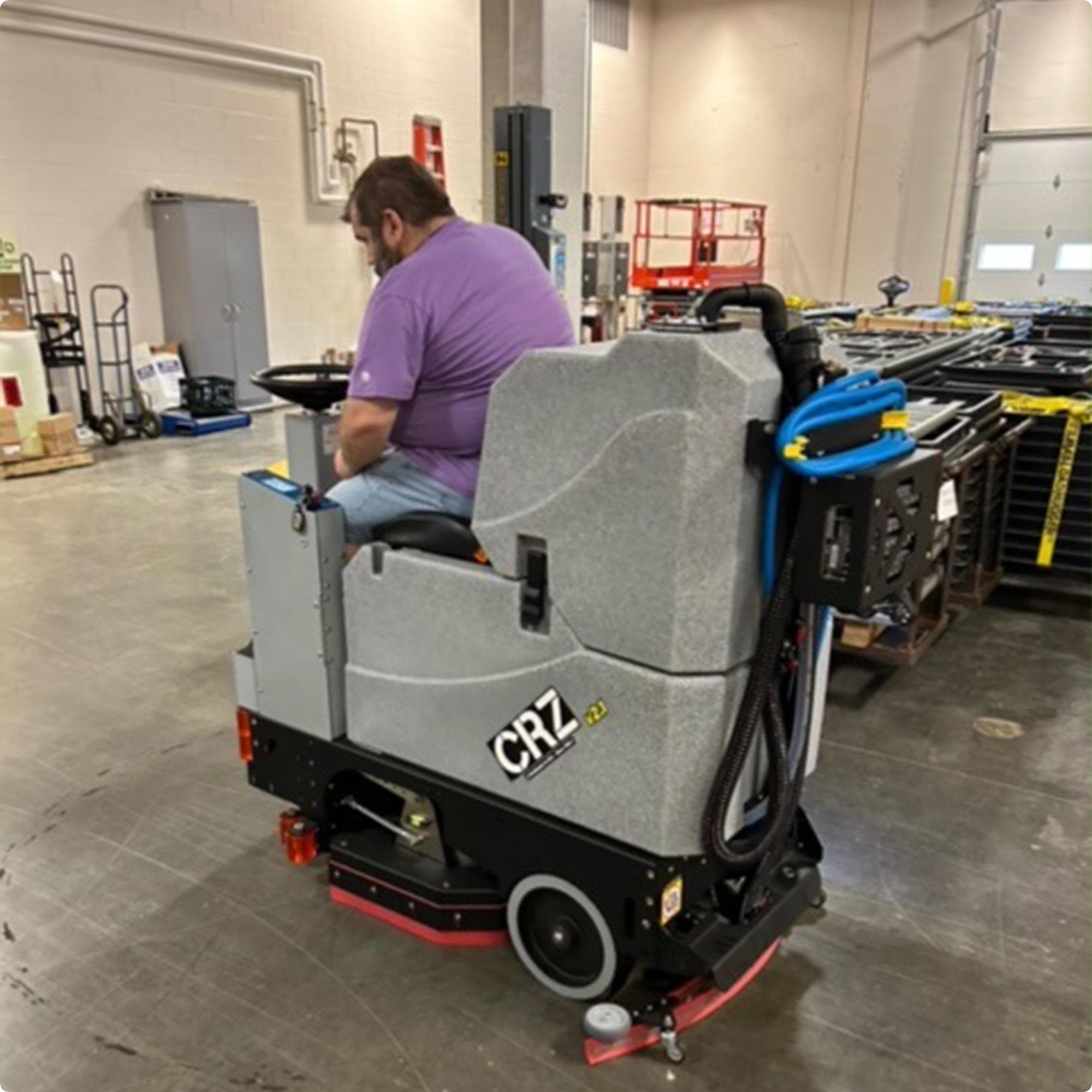 Tomcat CRZ 34" Disk Deck Ride On Floor Scrubber cleaning concrete in the warehouse of a high school IMG00038