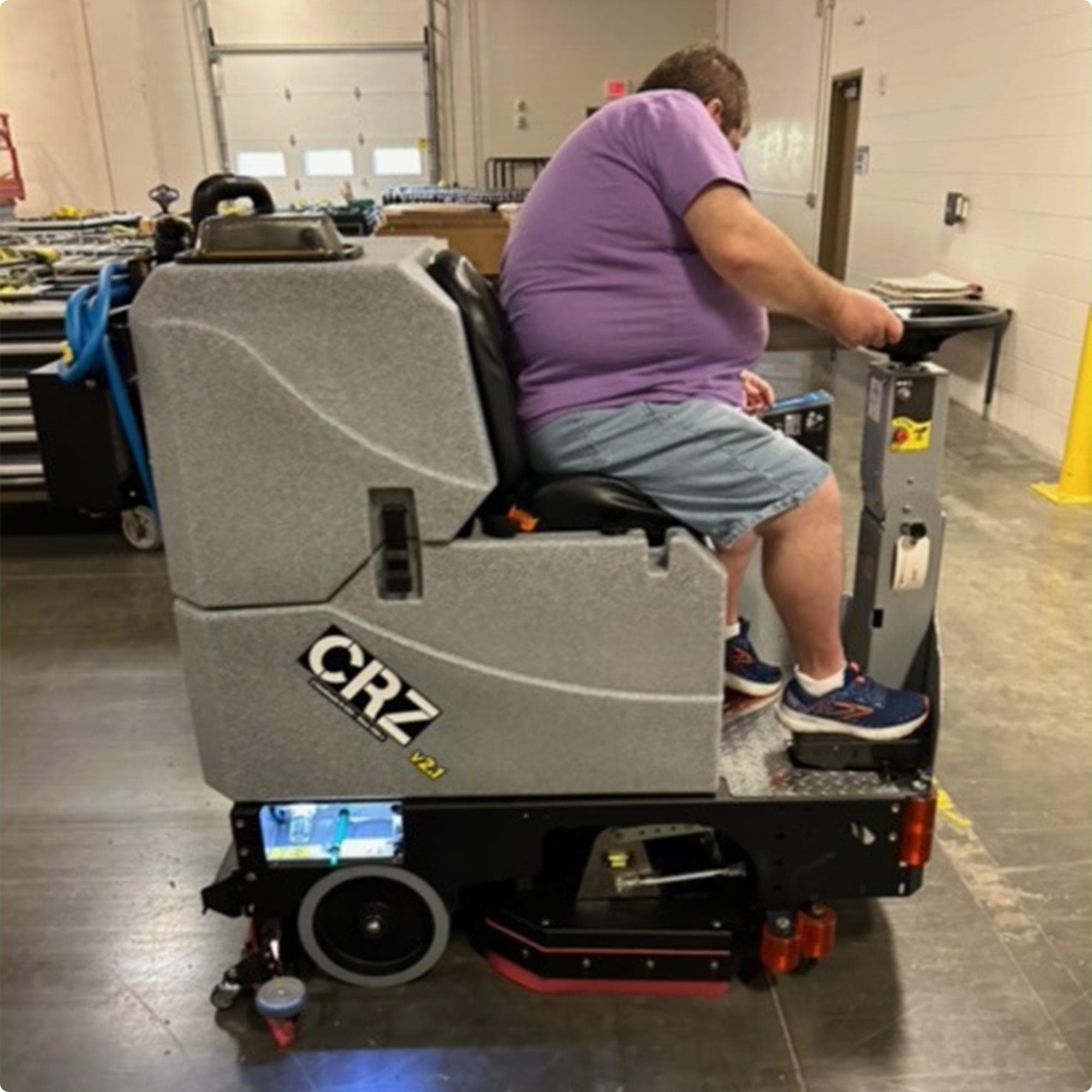 Tomcat CRZ 34" Disk Deck Ride On Floor Scrubber cleaning concrete in the warehouse of a high school IMG00041