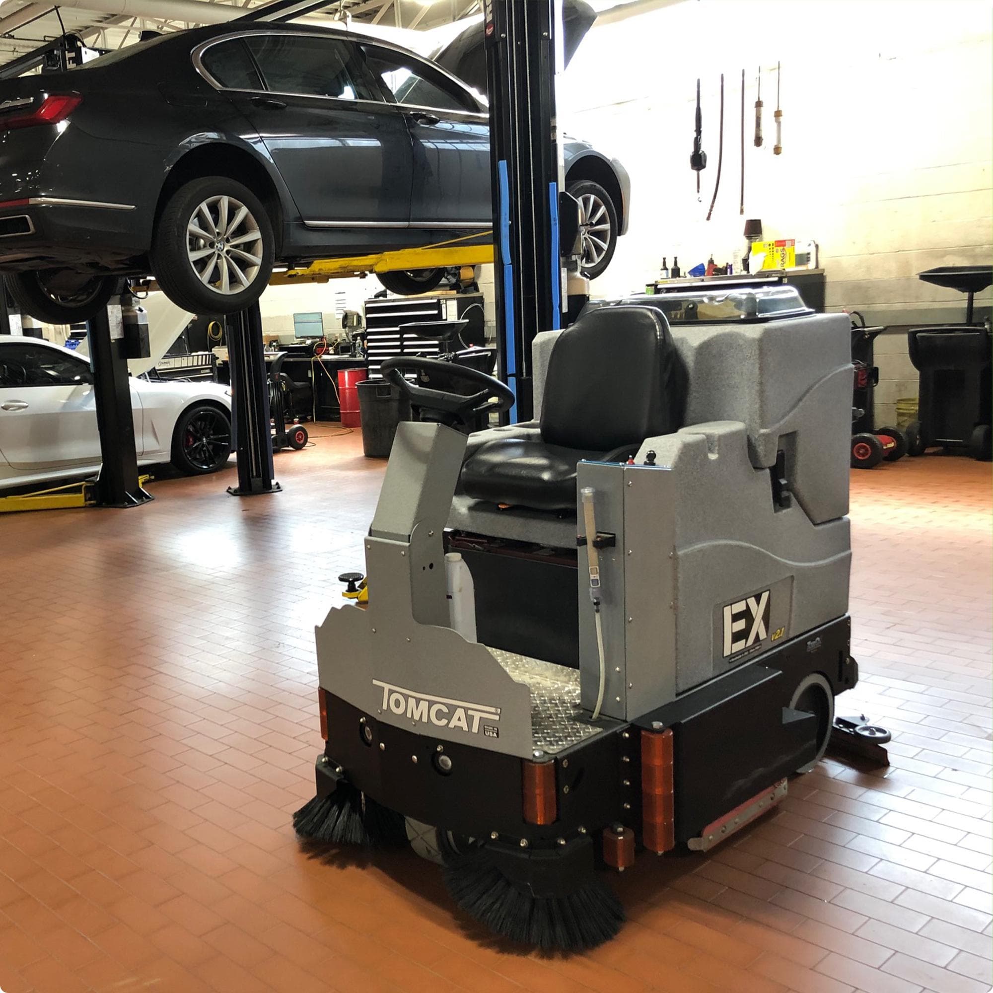 Tomcat EX 34" cylindrical deck ride on floor scrubber cleaning a brick floor in a service area in New Jersey IMG00018