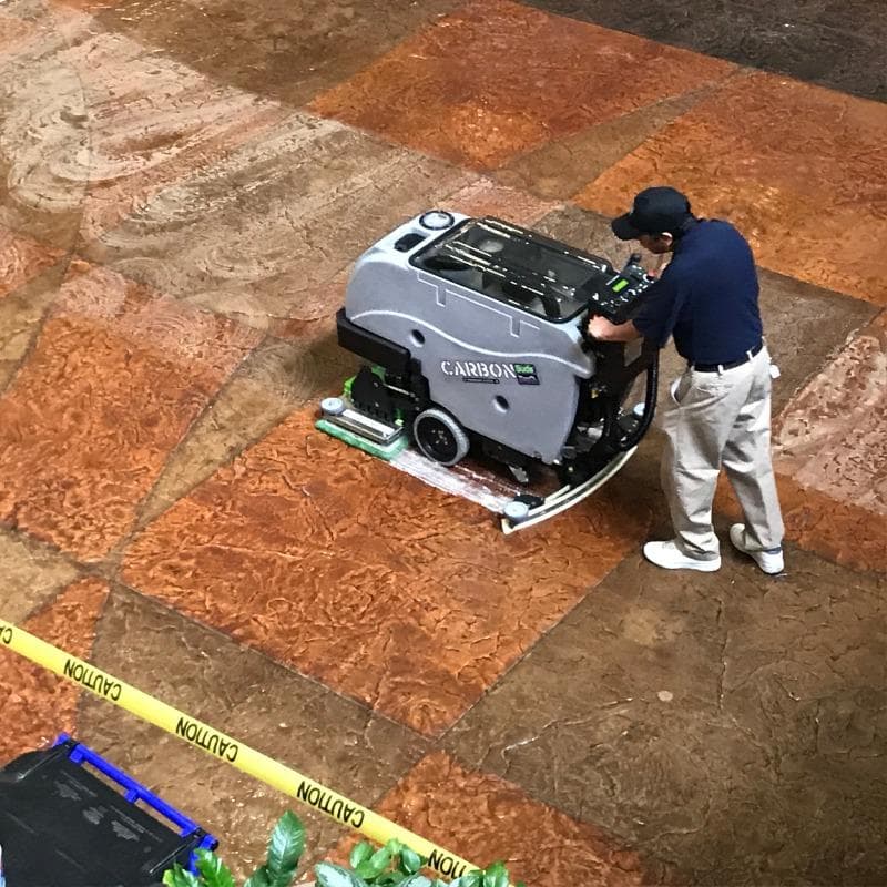 Tomcat Walk Behind Floor Scrubbers Carbon lobby epoxy CARBON Walk Behind Floor Scrubber cleans the epoxy coated stamped concrete in a Las Vegas Casino