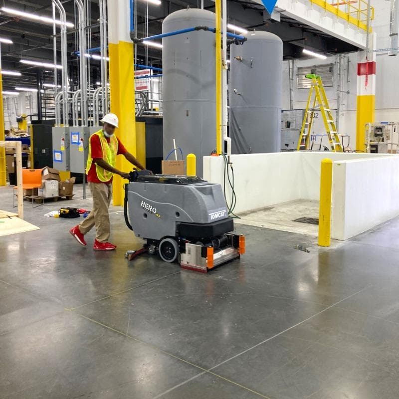 Tomcat Walk Behind Floor Scrubbers Hero production areas concrete HERO Walk Behind Floor Scrubber cleaning the densified concrete floors in the production area of a Salt Lake City, Utah chemical manufacturer